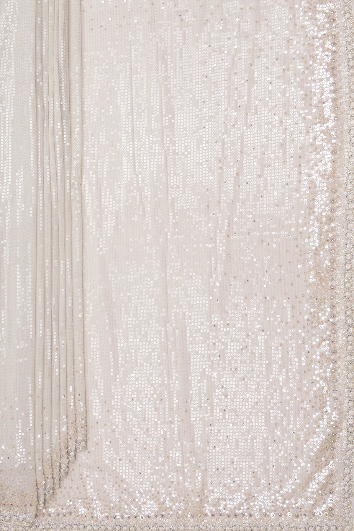 Pleats and pallu of Cream Georgette Saree with Embroidered on the body and Sequin Border. 
