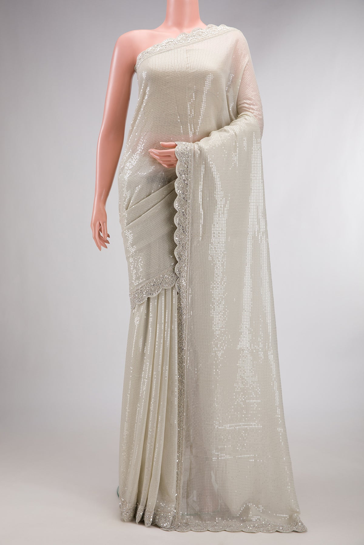 Beige Dual Tone Mysore Georgette Saree with Embroidered on the body and Sequin Border.  displayed on a mannequin