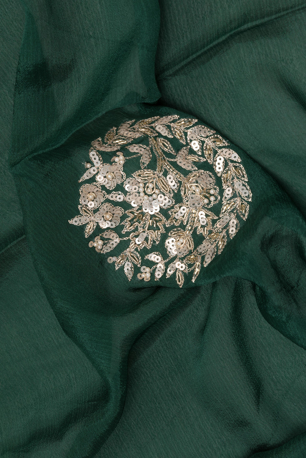 Close up of Bottle Green Crepe Saree with Embroidered on the body and Sequin Border.  displaying folds