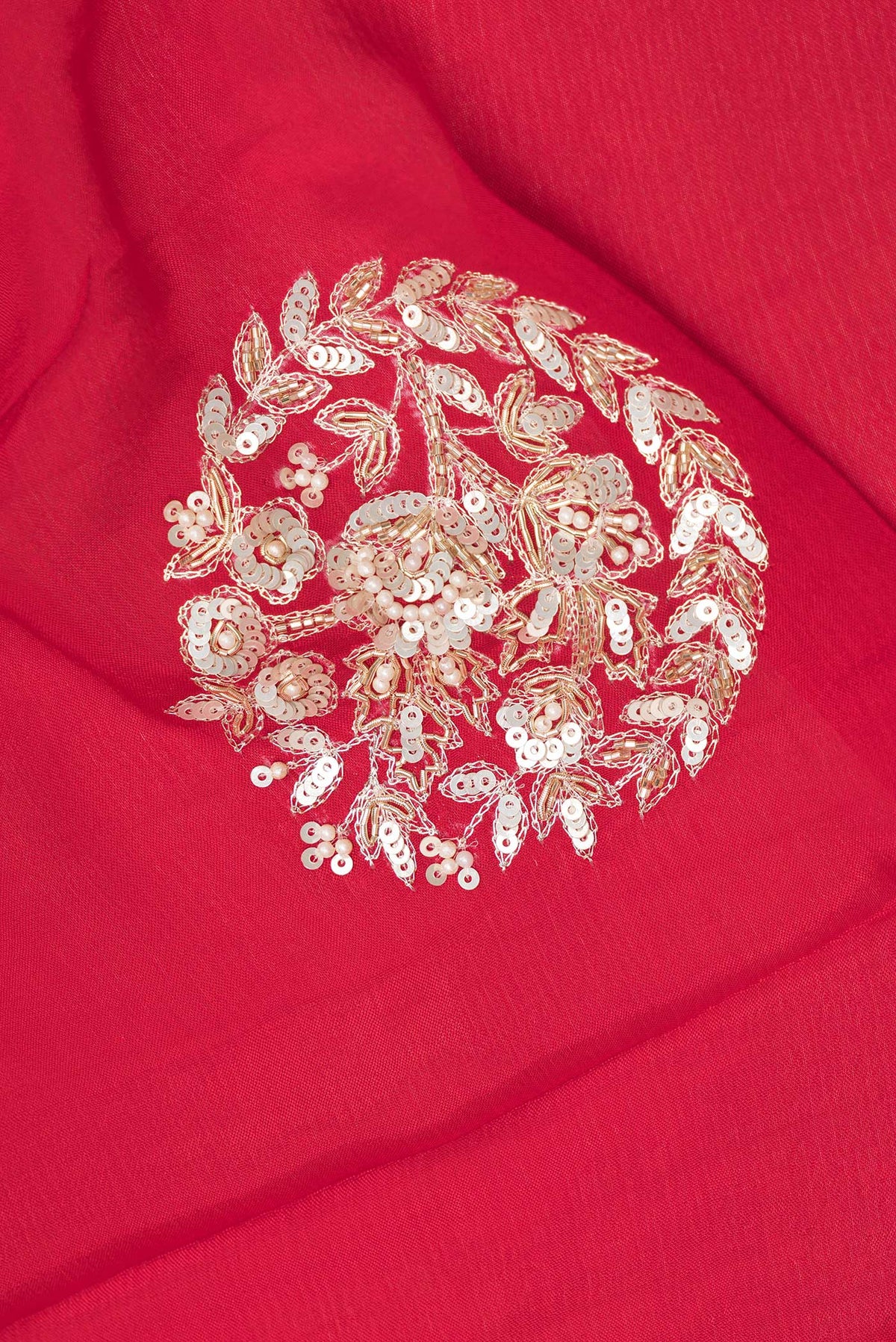 Close up of Red Crepe Saree with Embroidered on the body and Sequin Border.  displaying folds