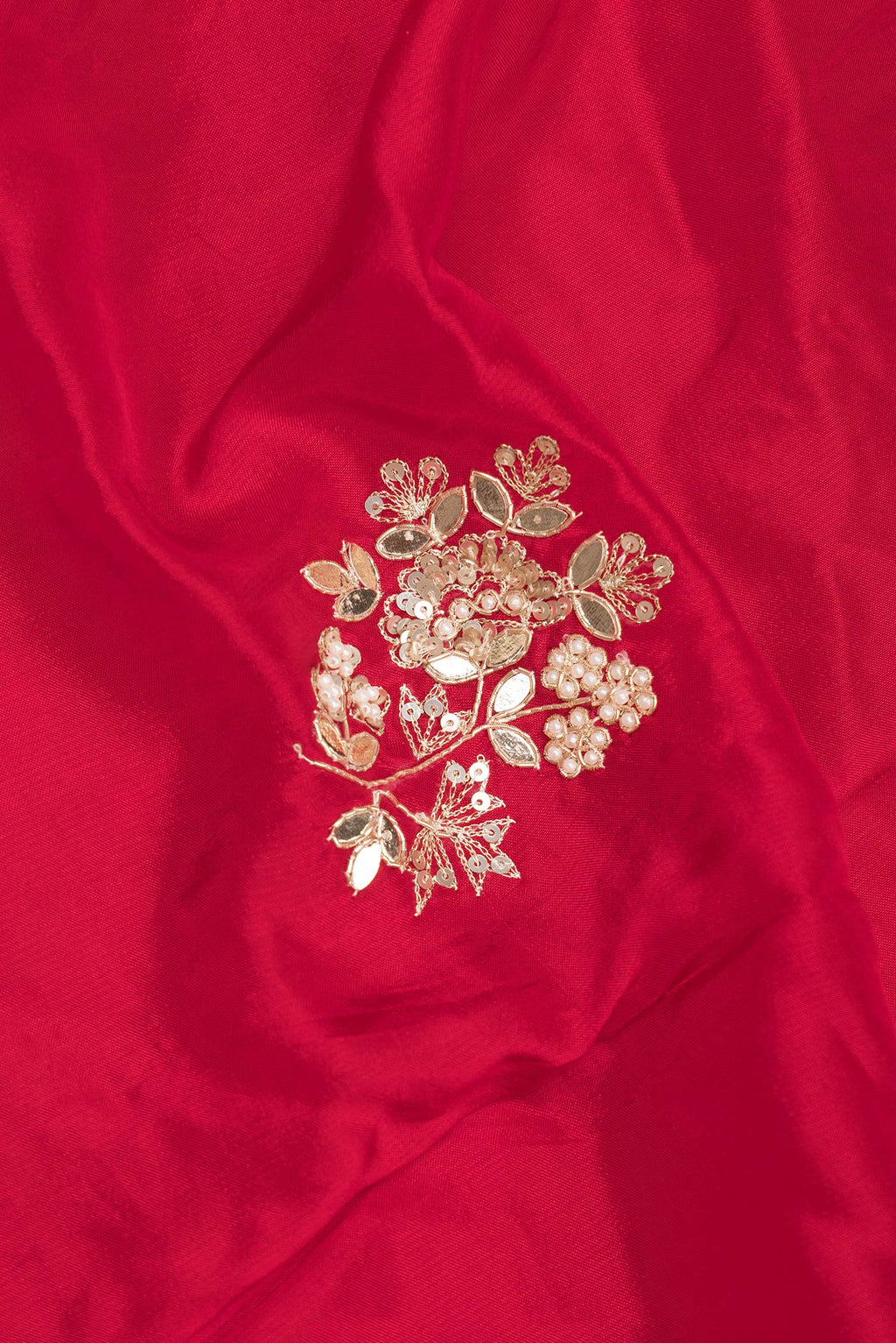 Close up of Red Crepe Saree with Embroidered on the body and Sequin Border.  displaying folds