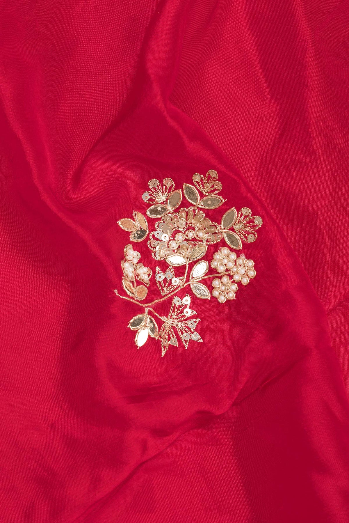 Close up of Red Crepe Saree with Embroidered on the body and Sequin Border.  displaying folds