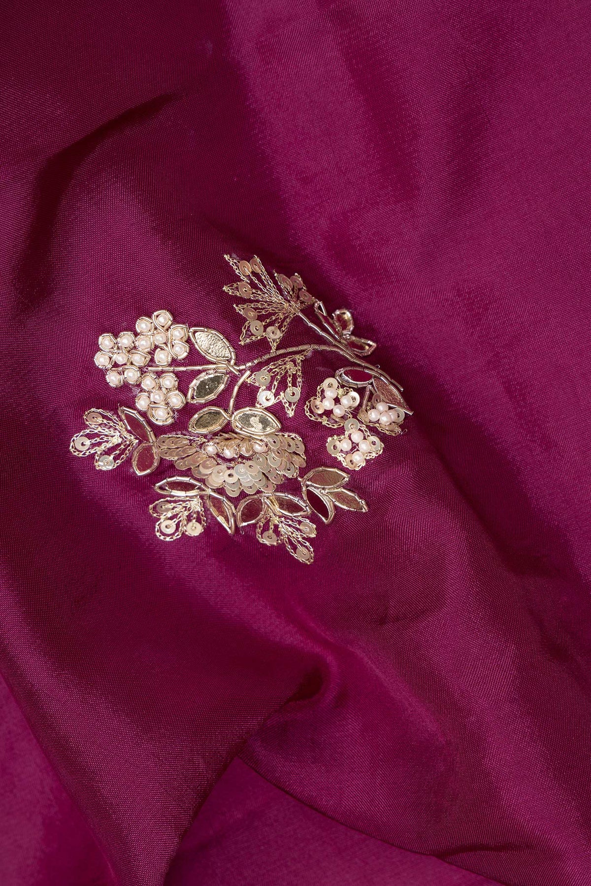 Close up of Magenta Crepe Saree with Embroidered on the body and Embroidered Border.  displaying folds