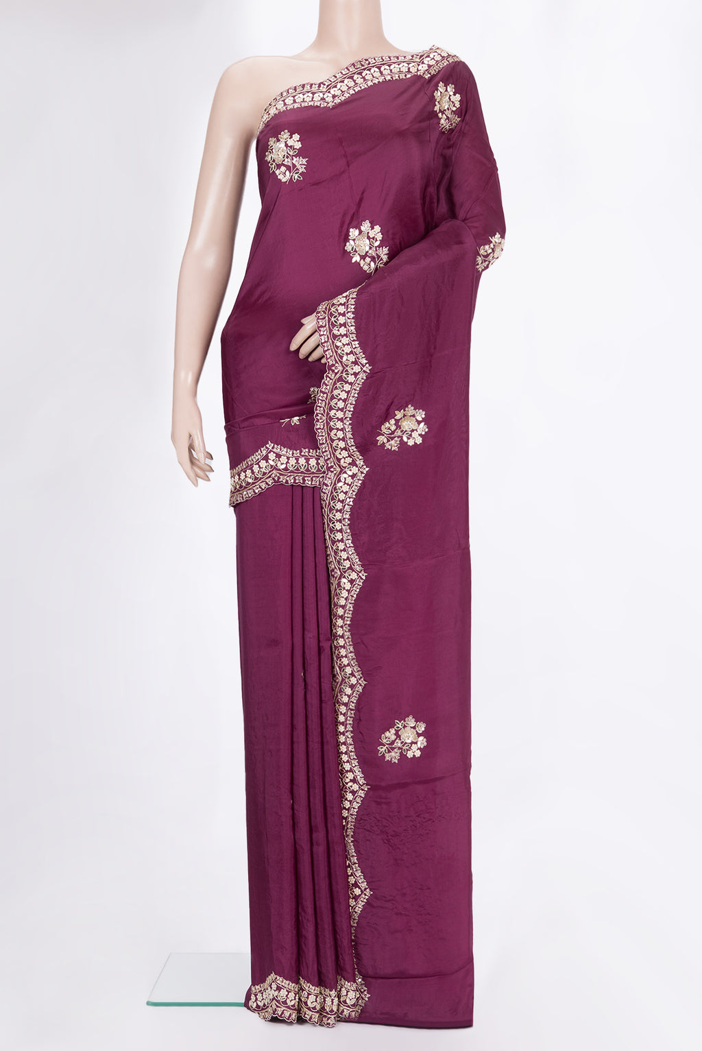 Magenta Crepe Saree with Embroidered on the body and Embroidered Border.  displayed on a mannequin