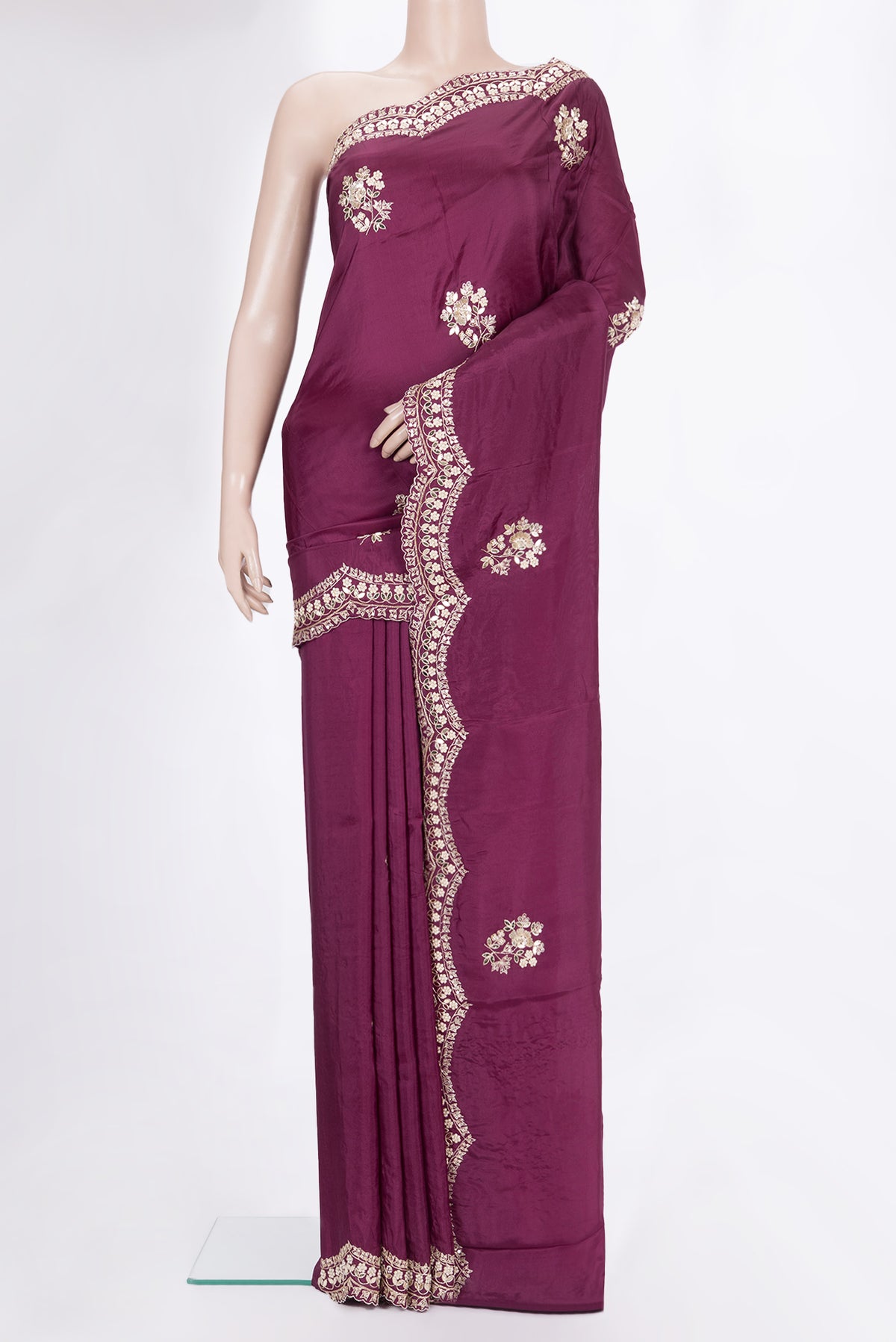 Magenta Crepe Saree with Embroidered on the body and Embroidered Border.  displayed on a mannequin