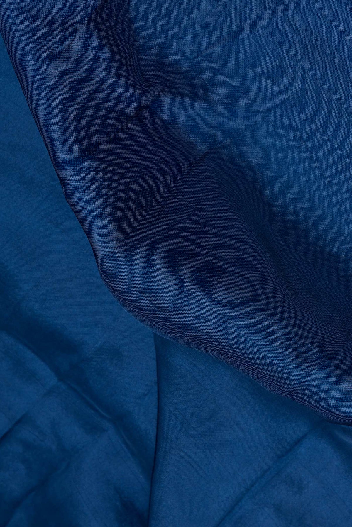 Close up of Peacock Blue Crepe Saree with Embroidered on the body and Embroidered Border.  displaying folds