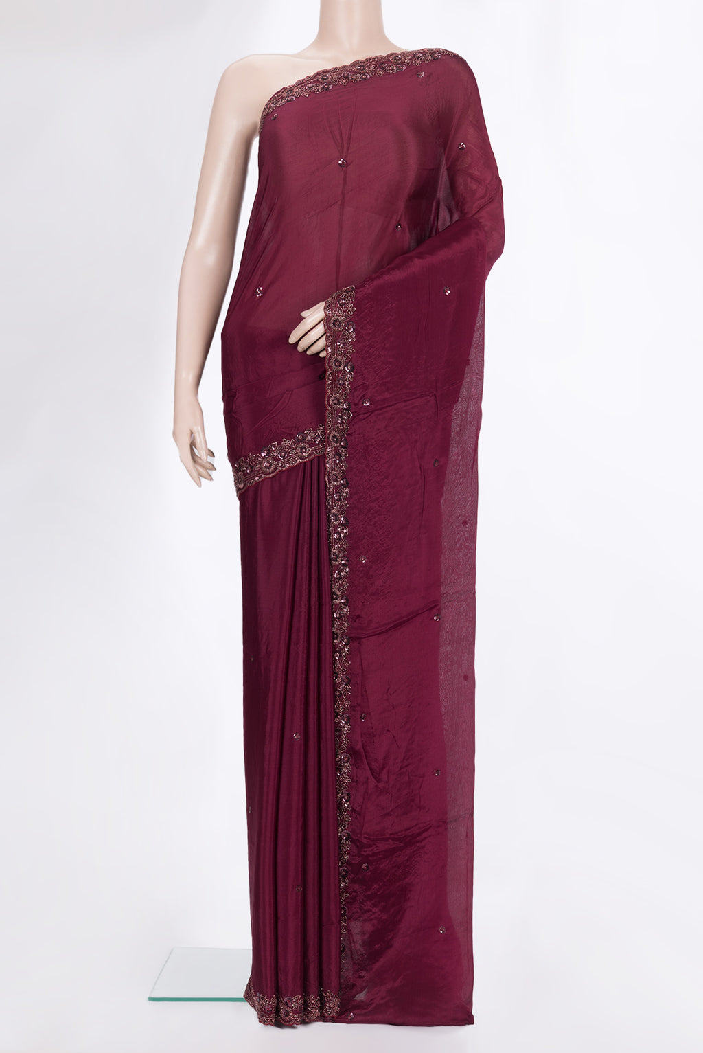 Maroon Crepe Saree with Embroidered on the body and Embroidered Border.  displayed on a mannequin