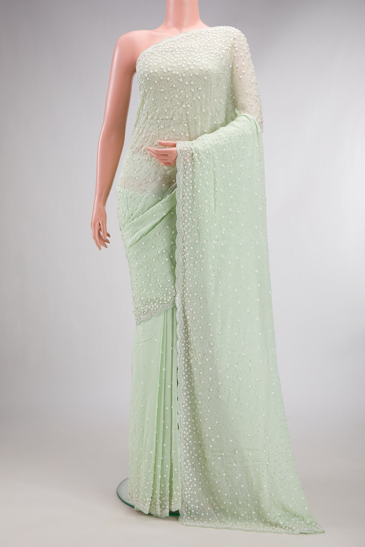 Light Green Dual Tone Mysore Georgette Saree with Embroidered on the body and Sequin Border.  displayed on a mannequin