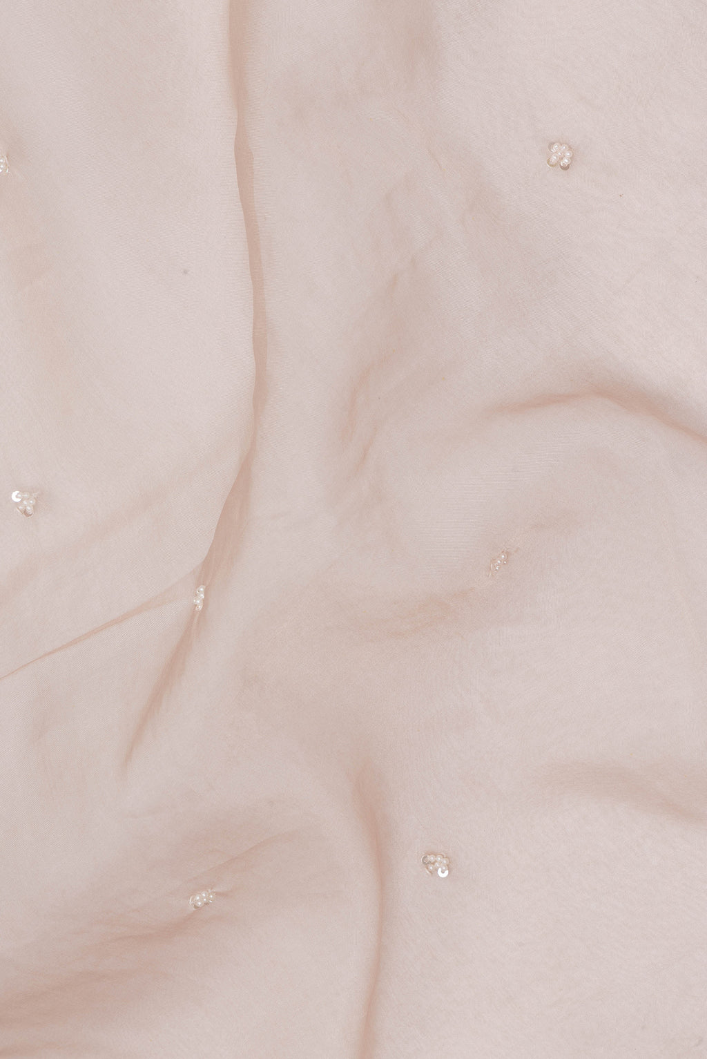 Close up of Dark Beige Organza Saree with Embroidery on the body and Sequin Border.  displaying folds