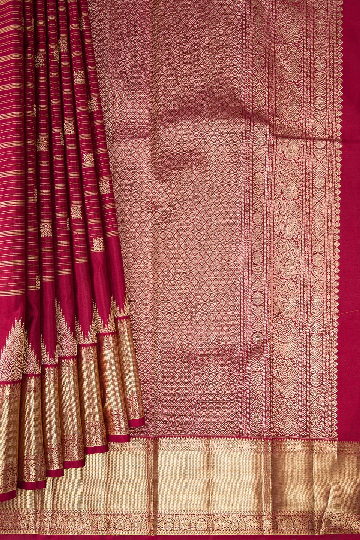 Pleats and pallu of Pure Silk Maroon Kanchipuram Saree with Stripes on the body and Zari Border. 