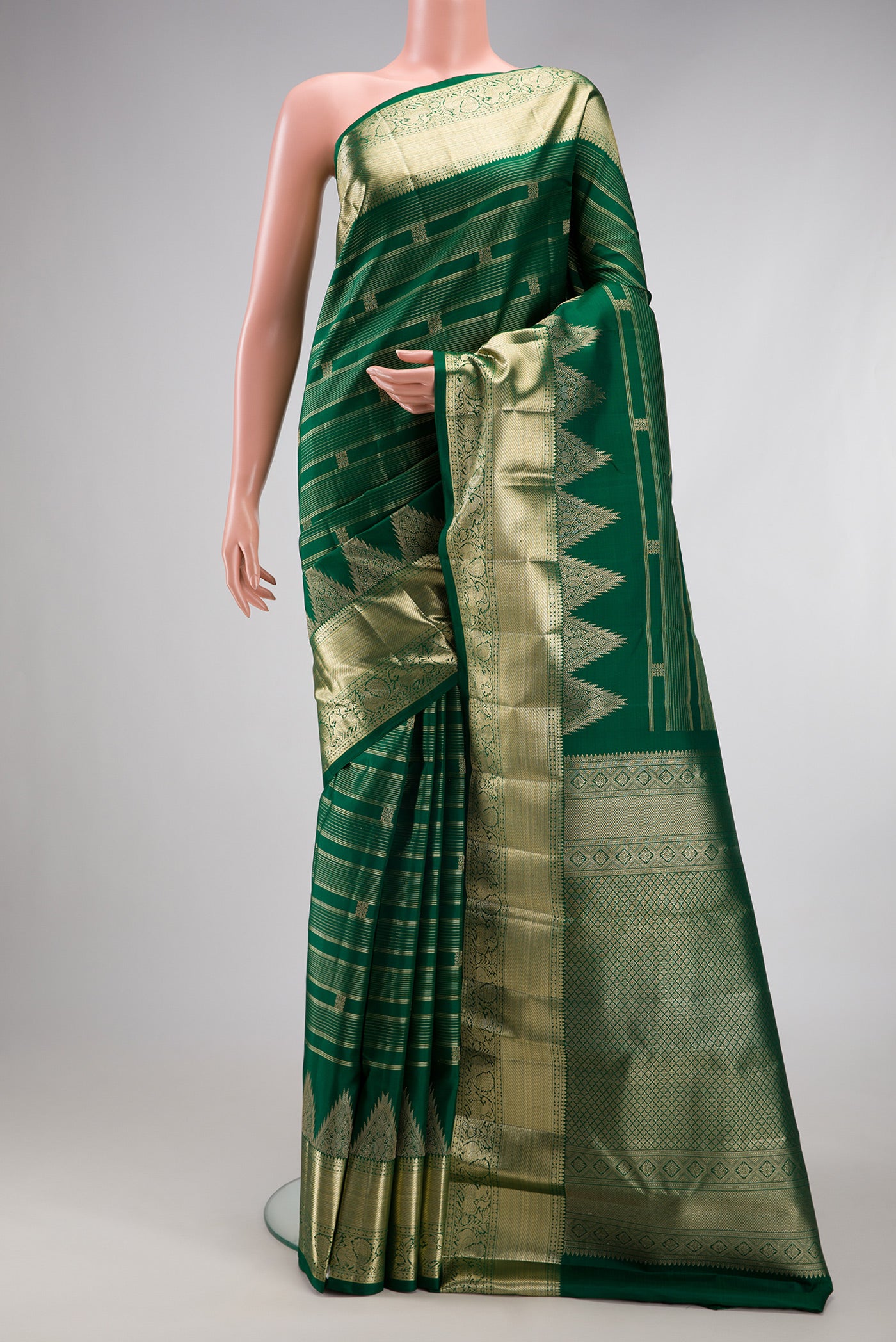Bottle Green Kanchipuram Silk Saree with Stripes on the body and Fancy Border.  displayed on a mannequin
