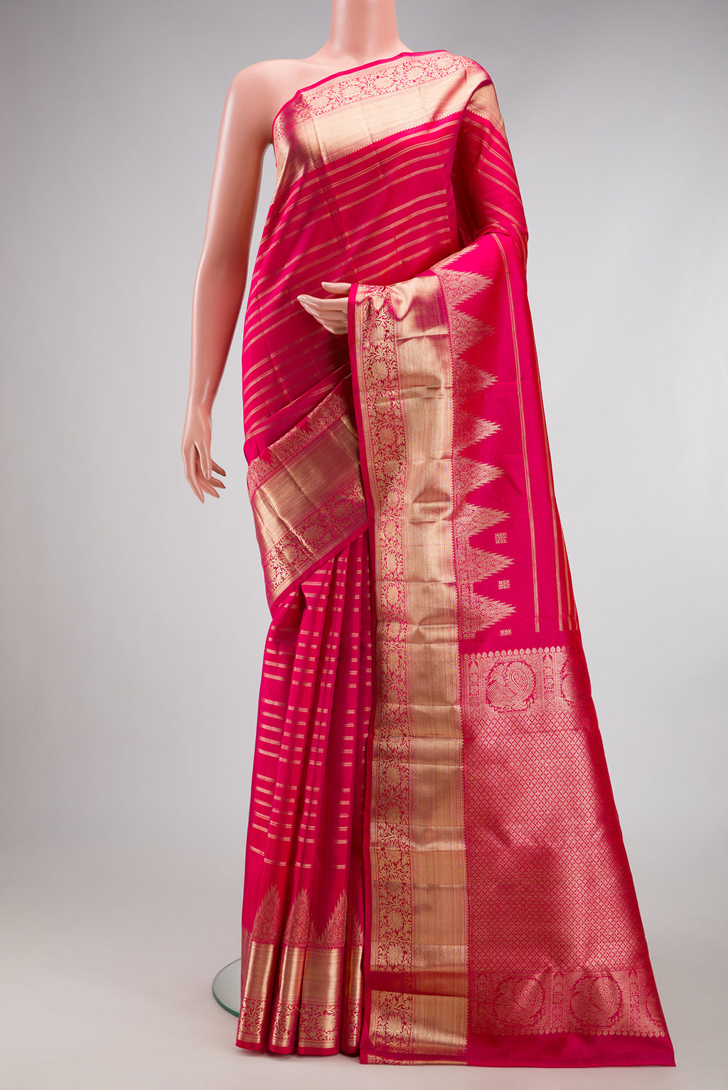 Dark Pink Dual Tone Kanchipuram Silk Saree with Stripes on the body and Fancy Border.  displayed on a mannequin
