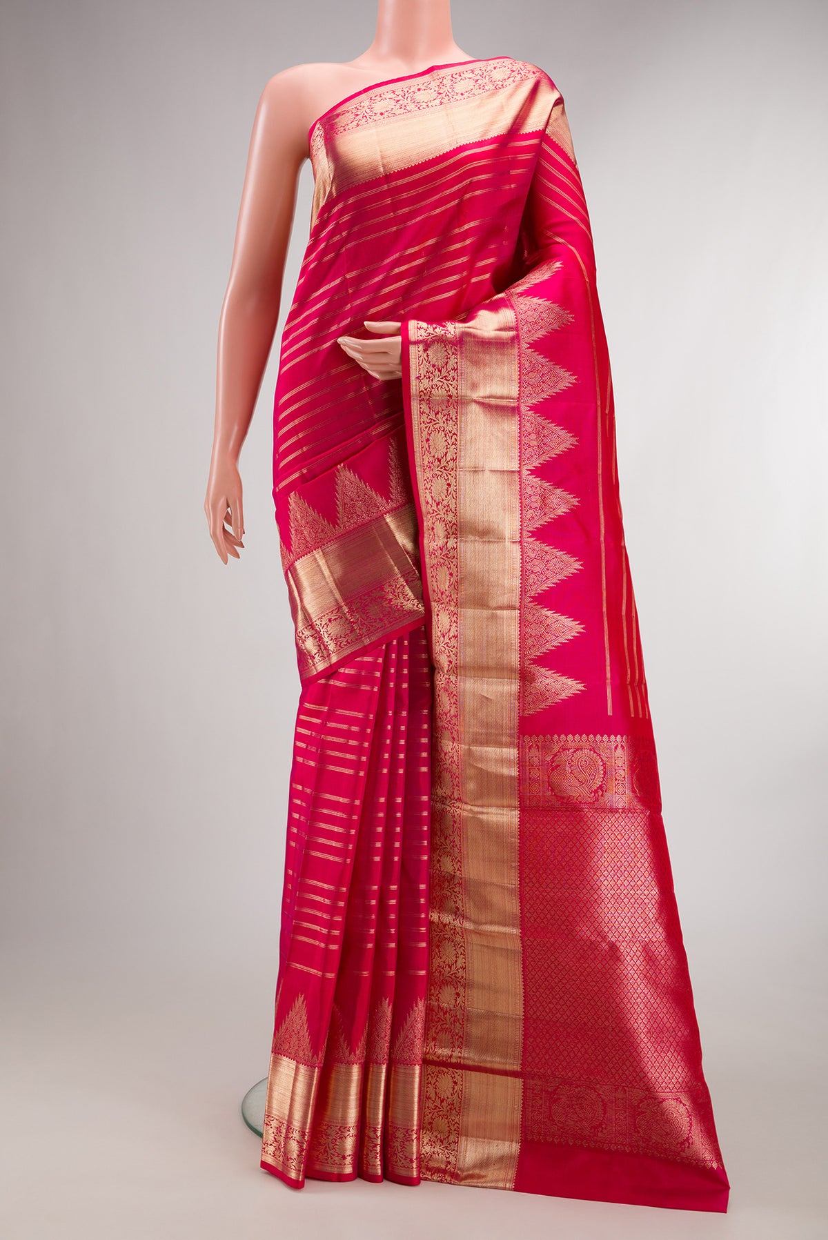 Pure Silk Pink Kanchipuram Saree with Stripes on the body and Fancy Border.  displayed on a mannequin