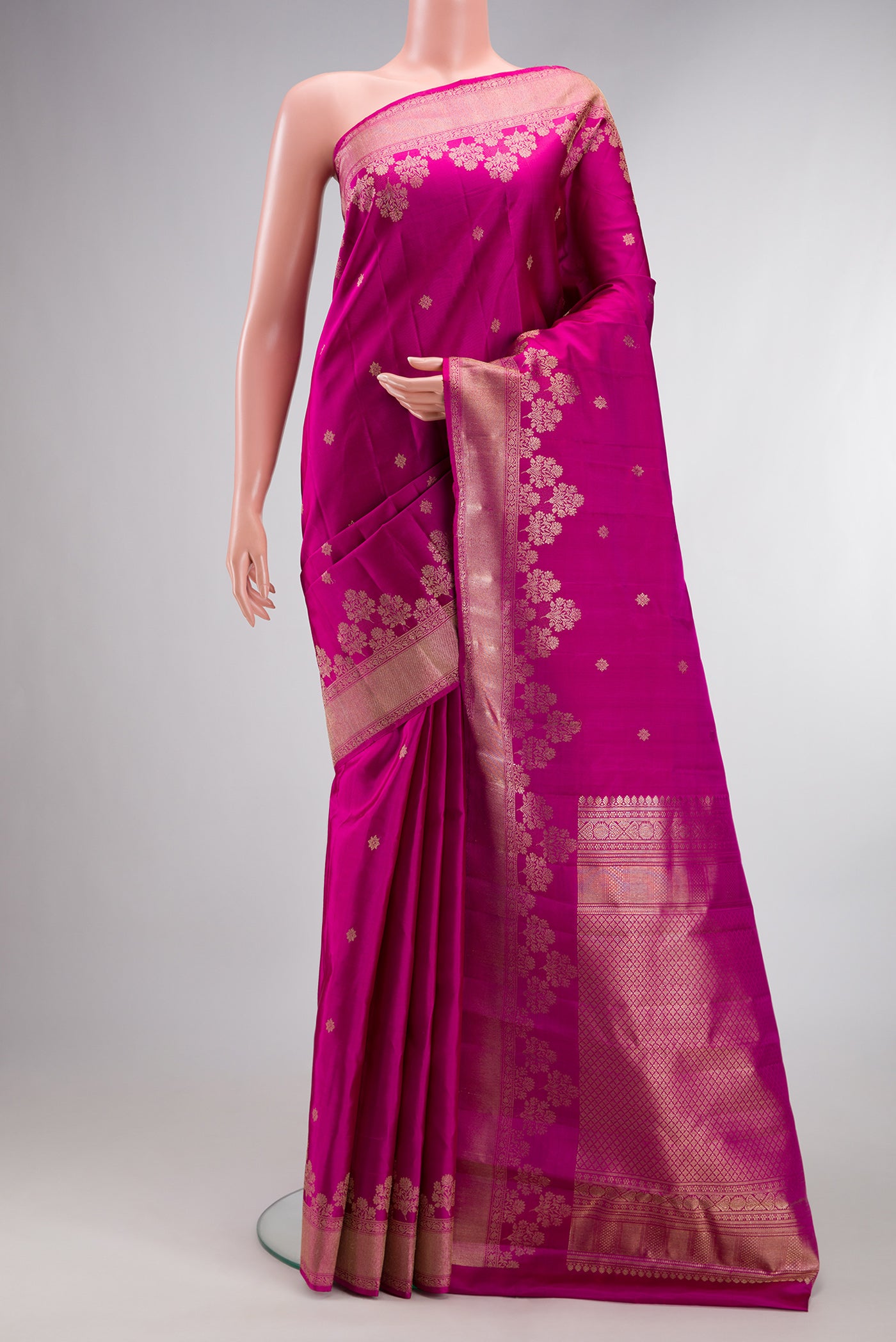 Pure Silk Magenta Kanjivaram Saree with Zari Butta on the body and Fancy Border.  displayed on a mannequin