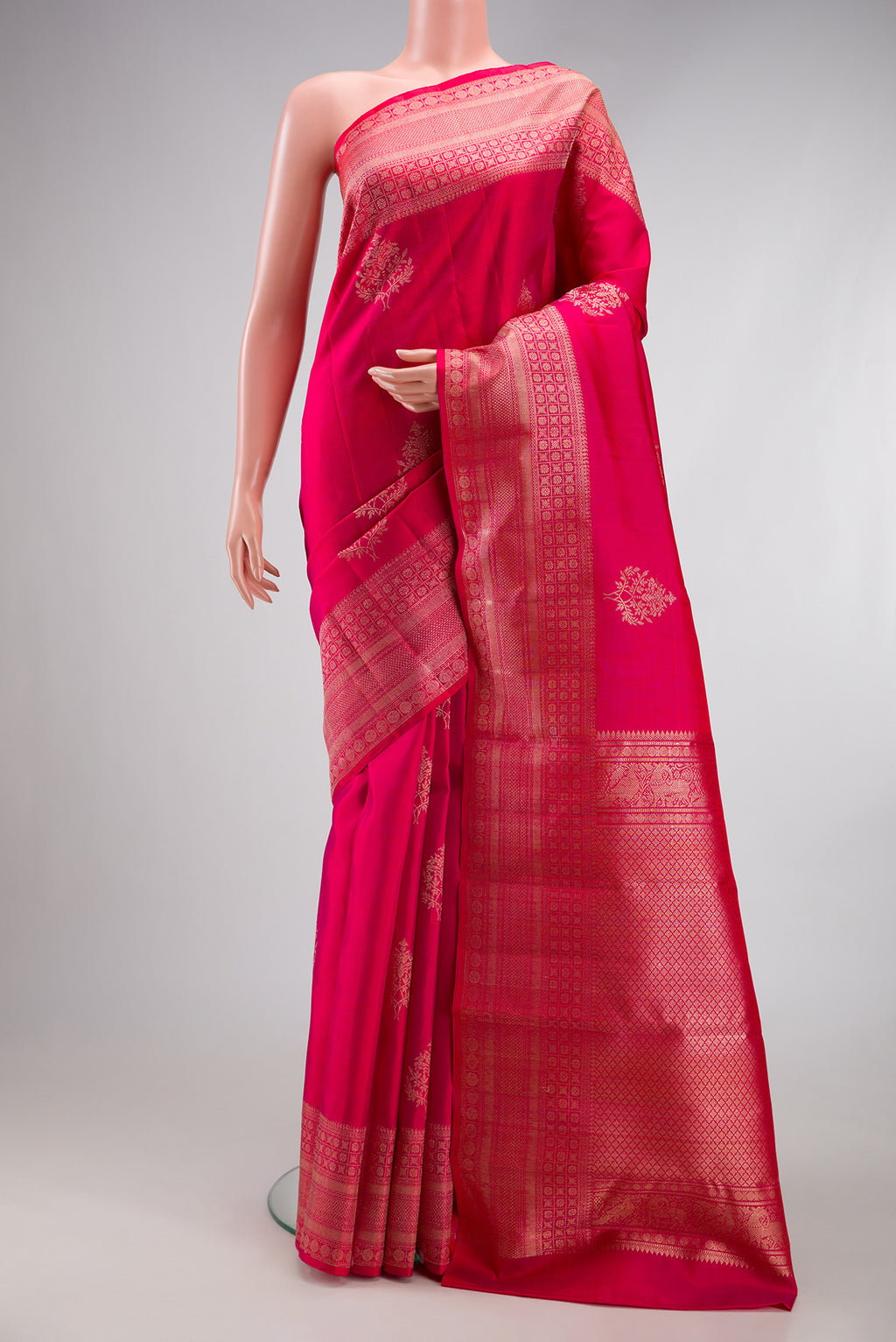 Dark Pink Kanjivaram Silk Saree with Zari Butta on the body and Zari Border.  displayed on a mannequin