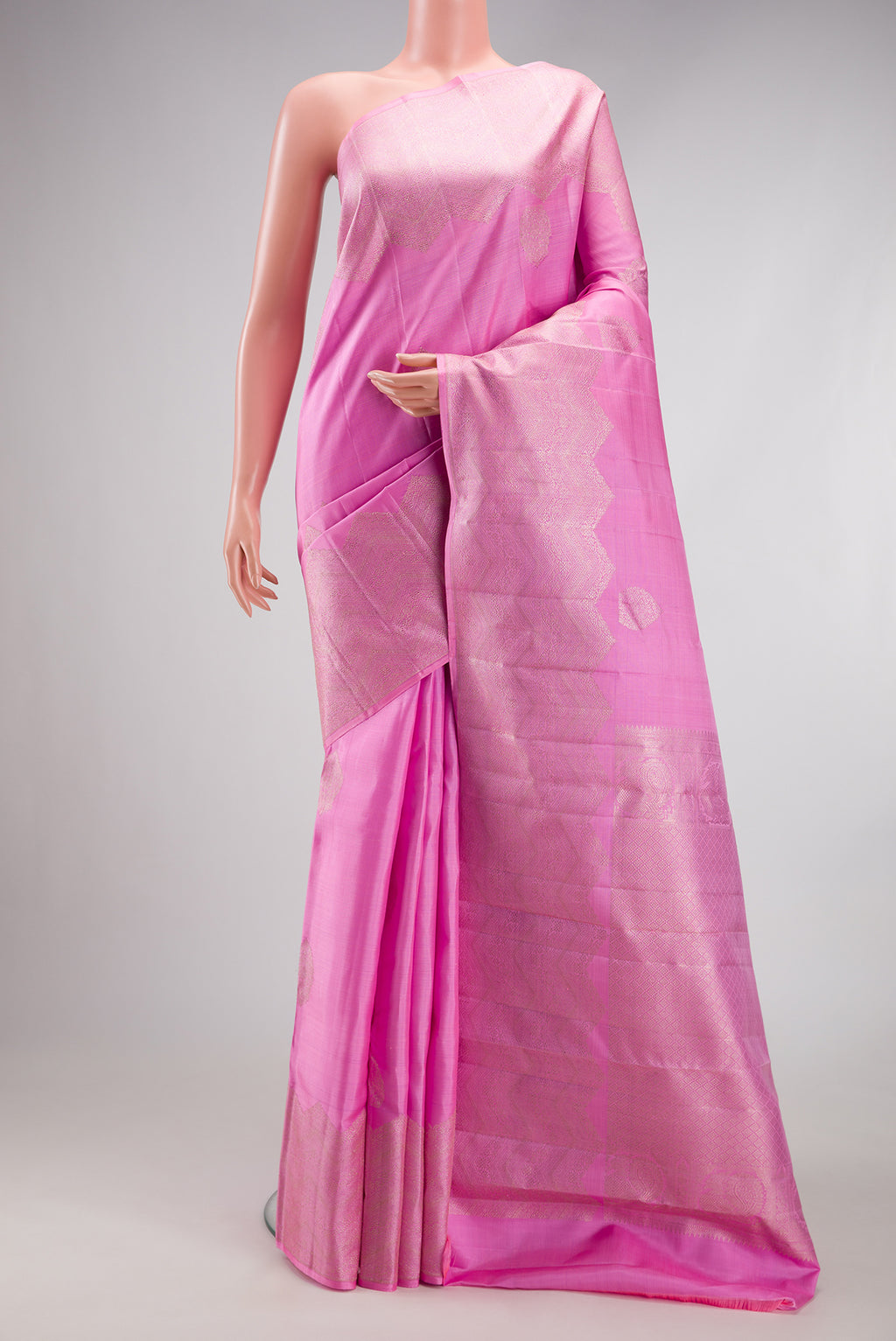Rose pink Kanjivaram Silk Saree with Zari Butta on the body and Fancy Border.  displayed on a mannequin