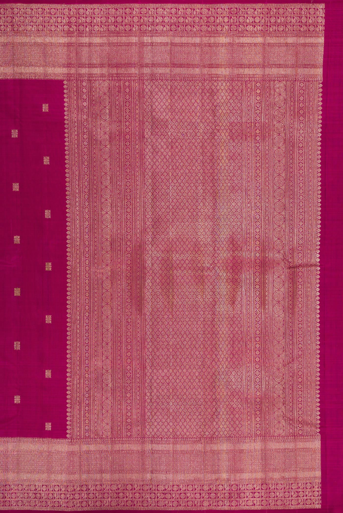 Close up image of the pallu of Magenta Kanjivaram Silk Saree with Zari Butta on the body and Fancy Border. 