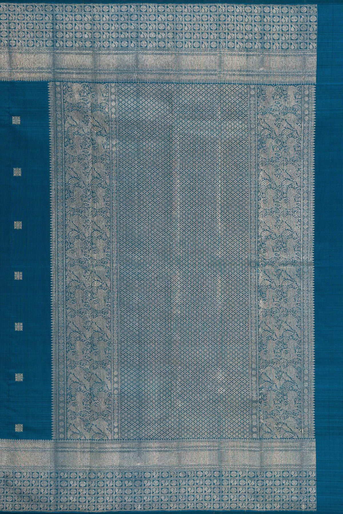 Close up image of the pallu of Pure Silk Peacock Blue Kanjivaram Saree with Zari Butta on the body and Fancy Border. 