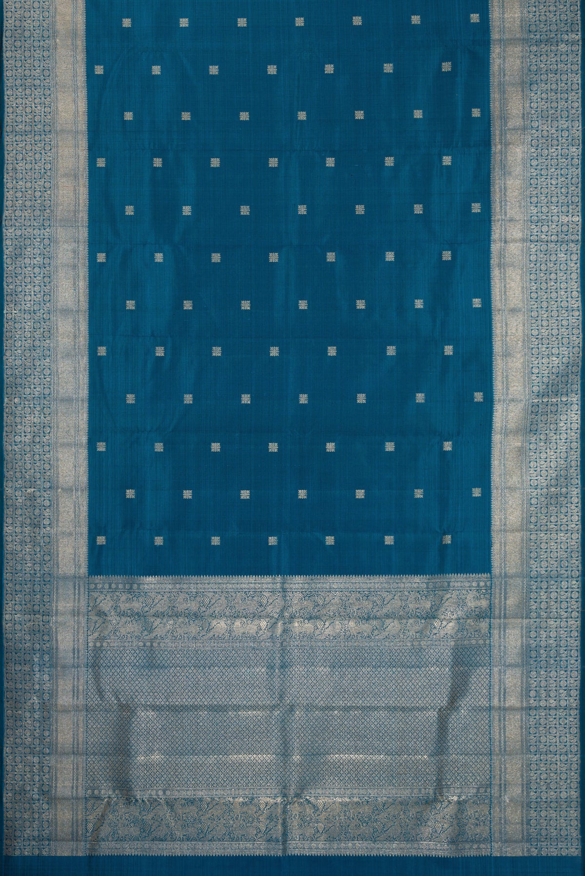 Flat view of Pure Silk Peacock Blue Kanjivaram Saree with Zari Butta on the body and Fancy Border. 