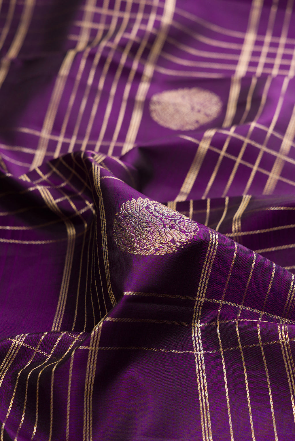 Close up of Pure Silk Violet Kanchipuram Saree with Checked design on the body and Zari Border.  displaying folds