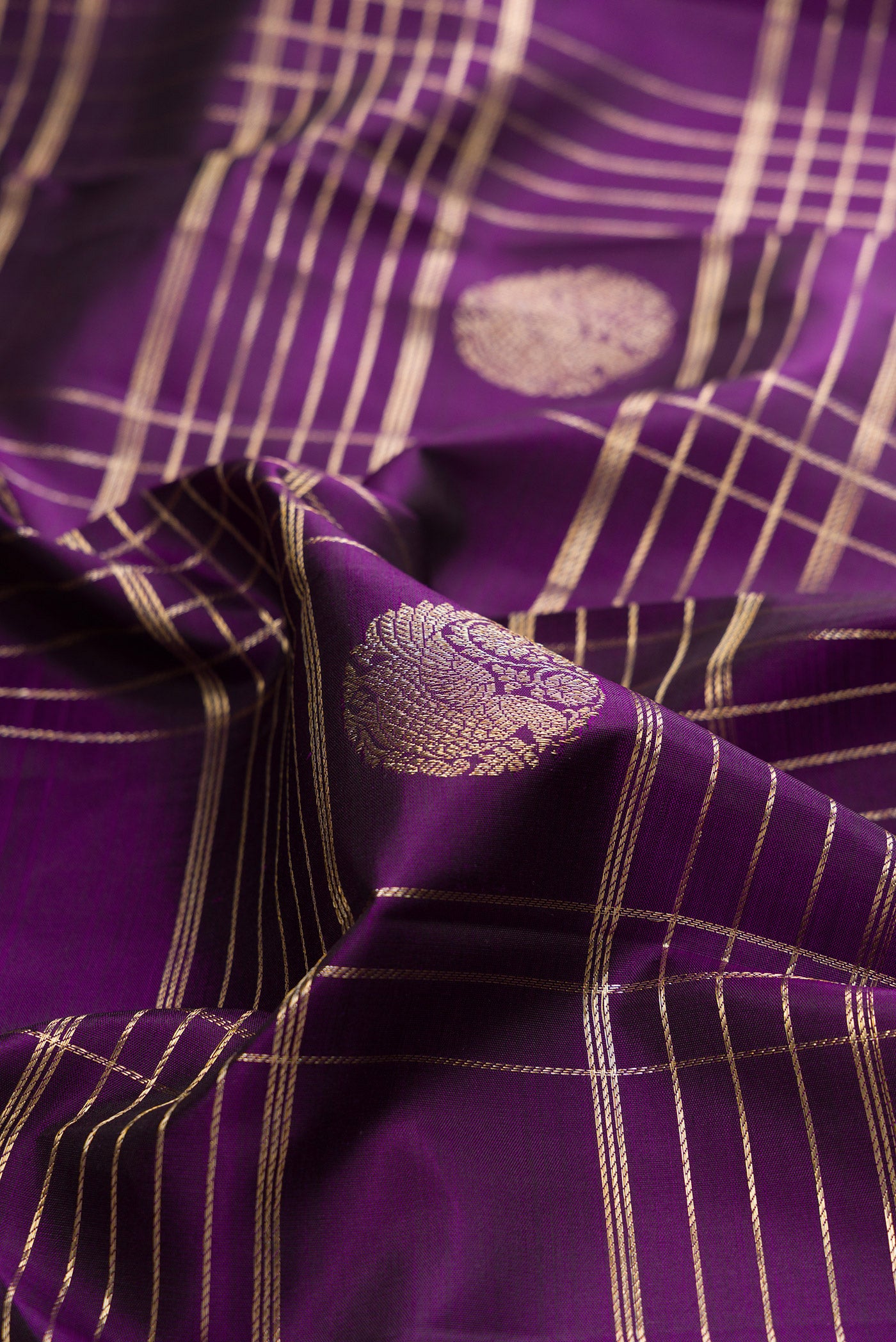 Close up of Pure Silk Violet Kanchipuram Saree with Checked design on the body and Zari Border.  displaying folds