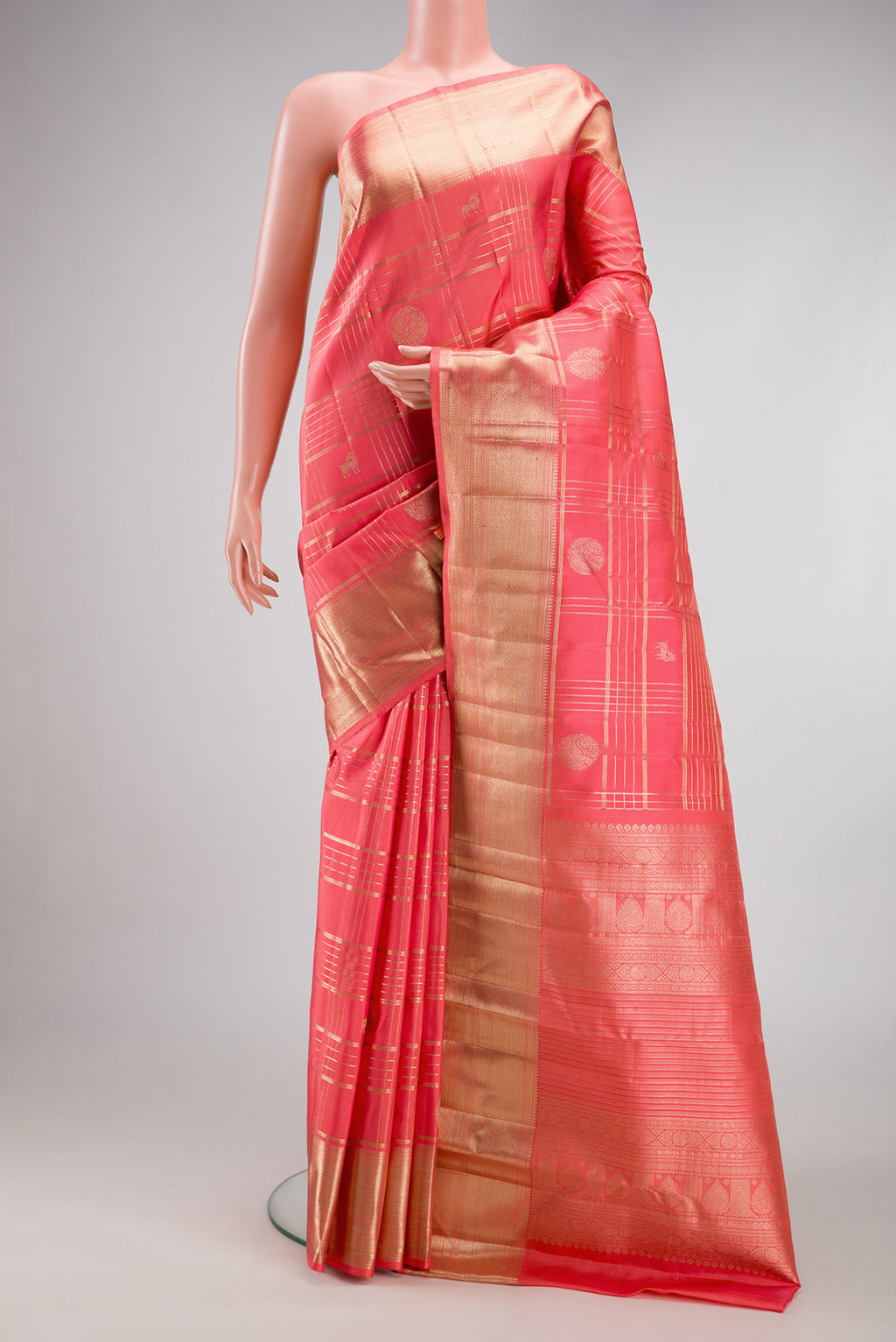 Coral Kanchipuram Silk Saree with Checked design on the body and Zari Border.  displayed on a mannequin