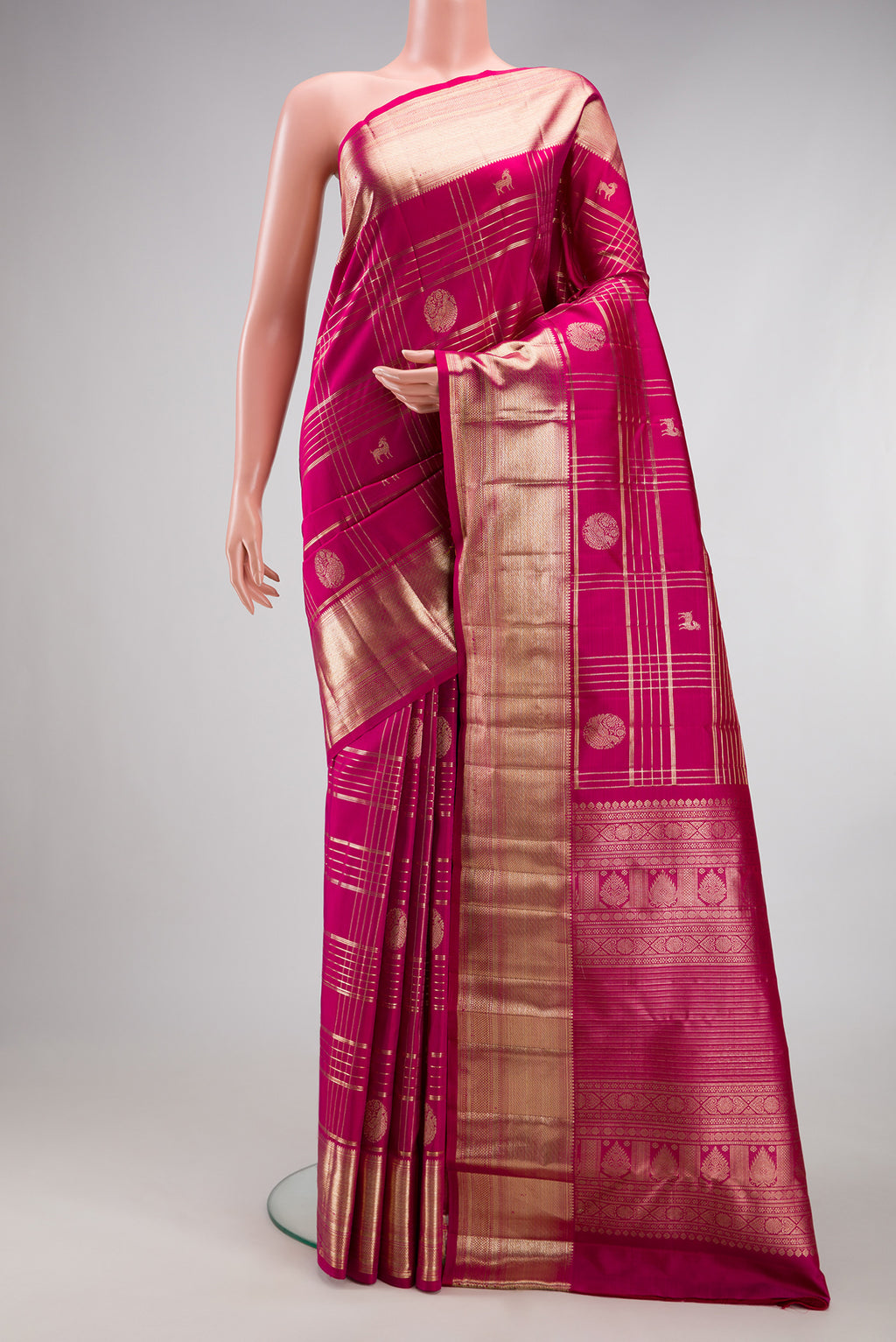 Magenta Kanchipuram Silk Saree with Checked design on the body and Zari Border.  displayed on a mannequin