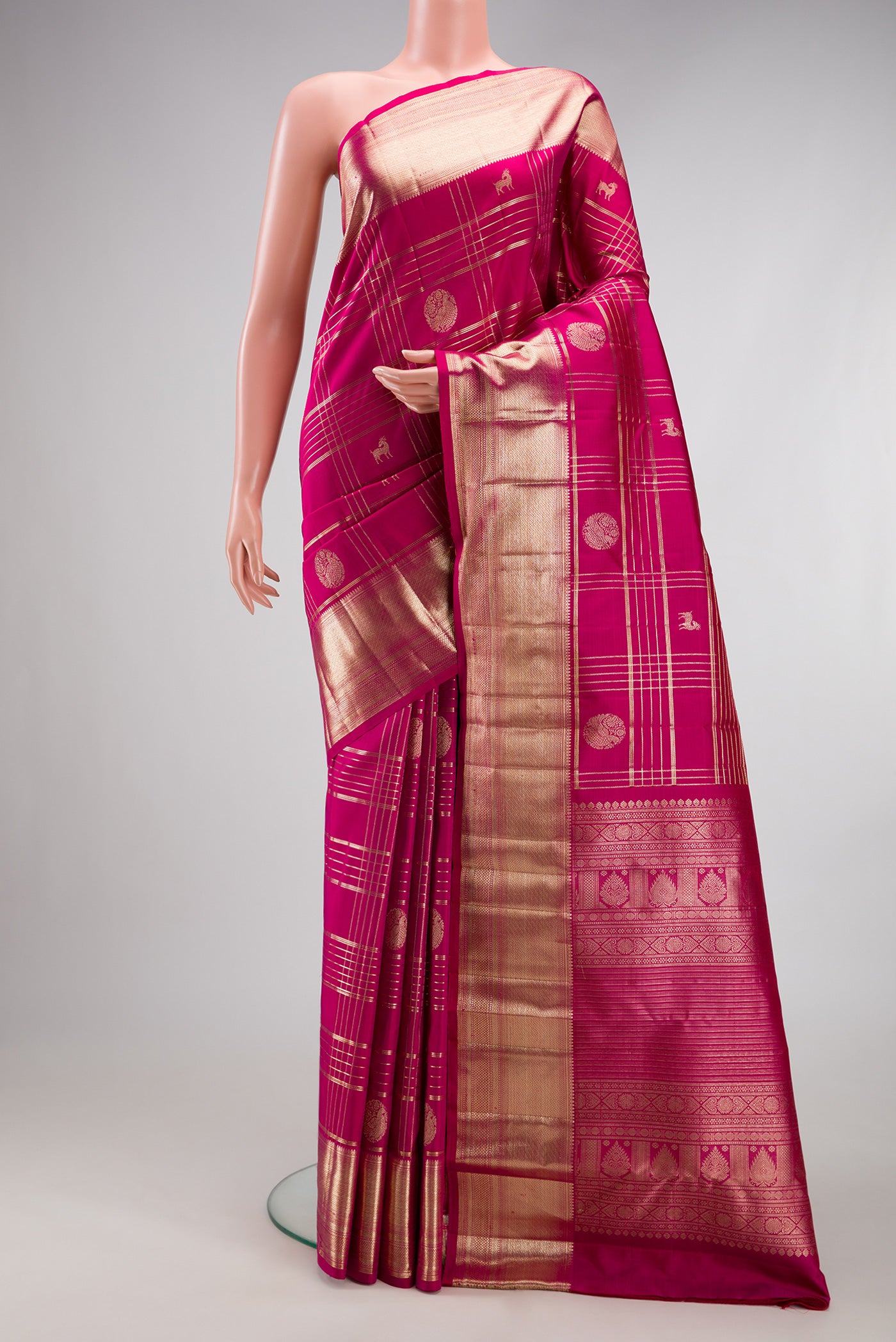 Magenta Kanchipuram Silk Saree with Checked design on the body and Zari Border.  displayed on a mannequin