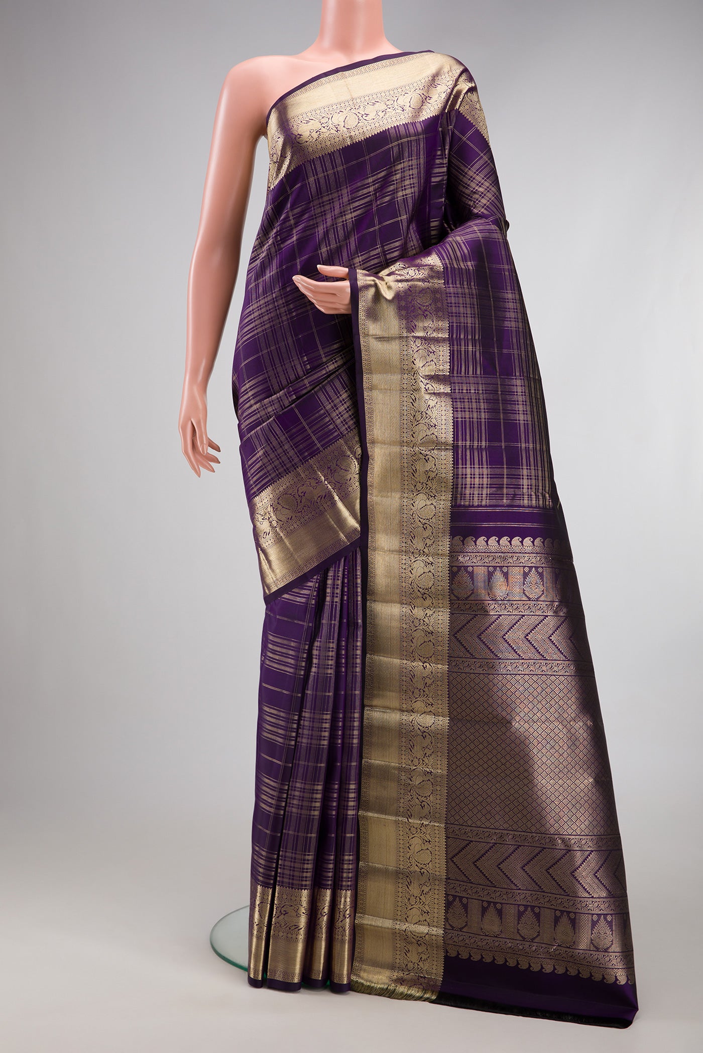 Violet Kanchipuram Silk Saree with Checked design on the body and Zari Border.  displayed on a mannequin