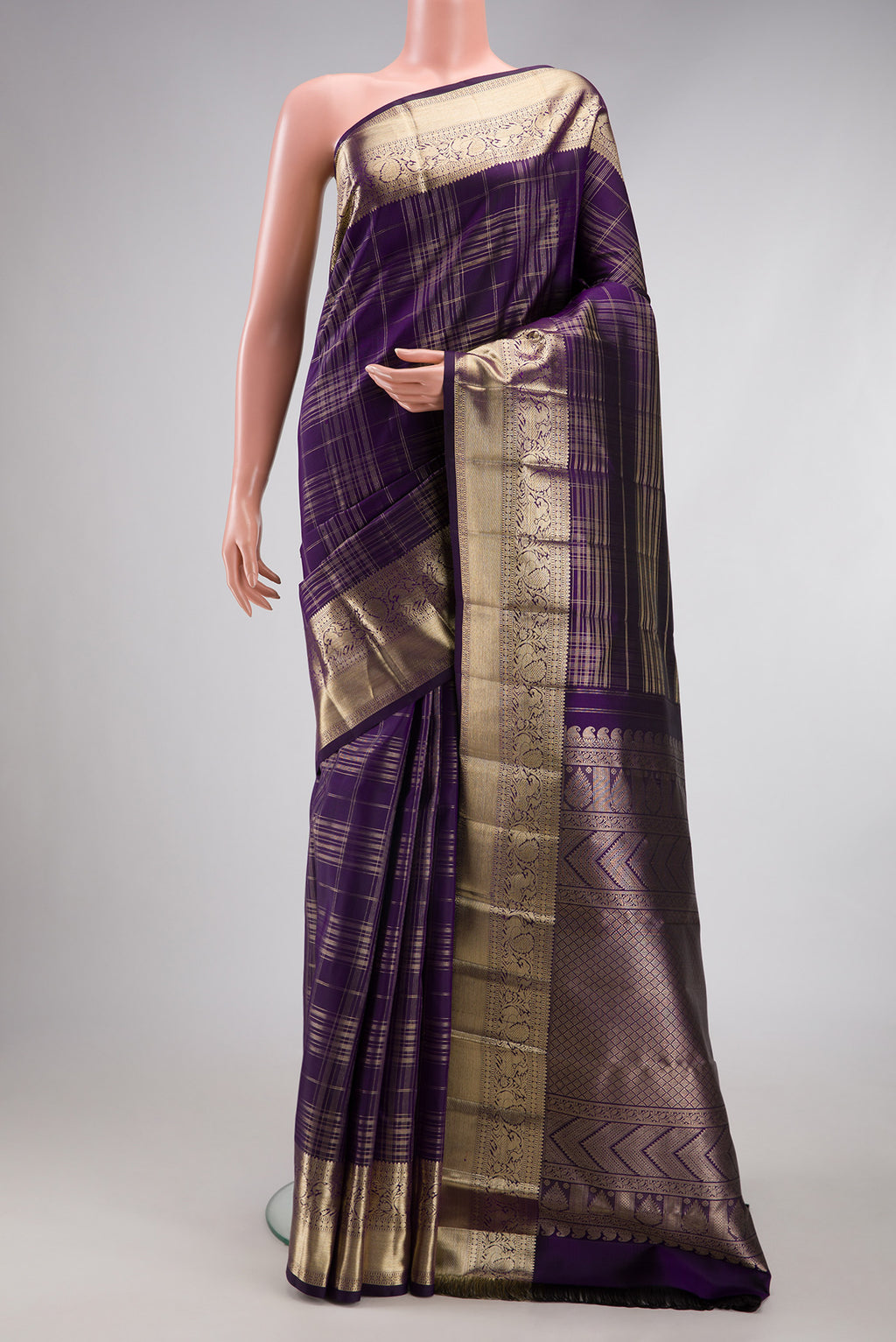 Violet Kanchipuram Silk Saree with Checked design on the body and Zari Border.  displayed on a mannequin