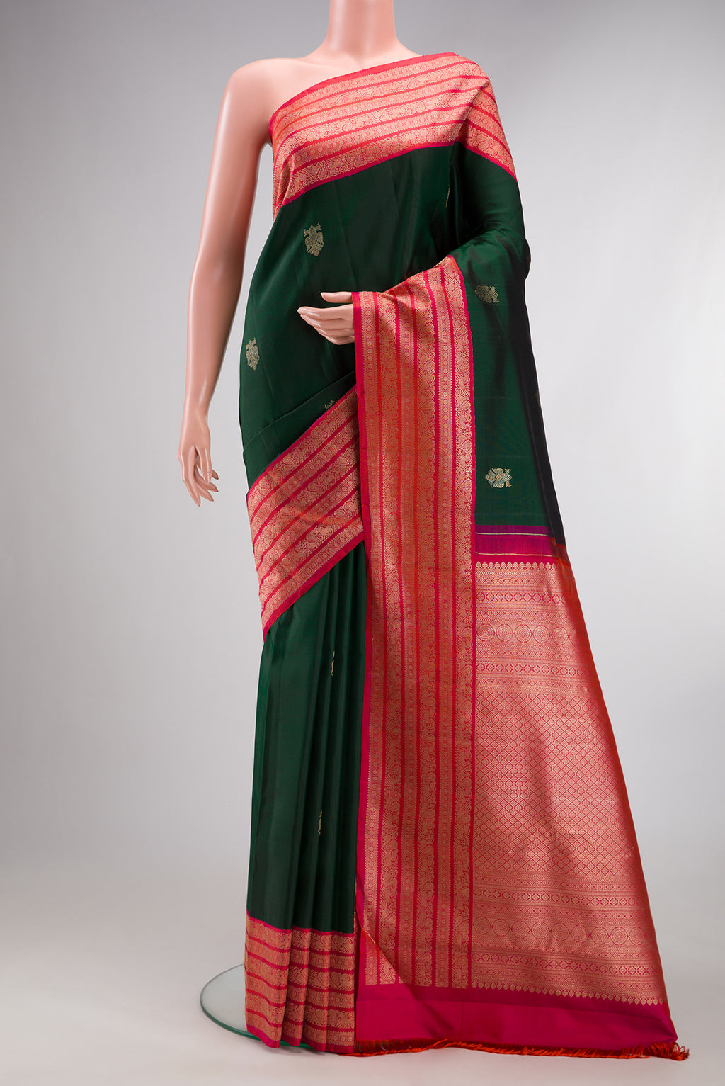 Pure Silk Bottle Green Kanchipuram Saree with Zari Butta on the body and Zari Border.  displayed on a mannequin