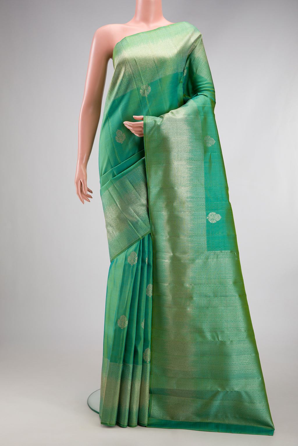 Sea Green Kanjivaram Silk Saree with Zari Butta on the body and Fancy Border.  displayed on a mannequin