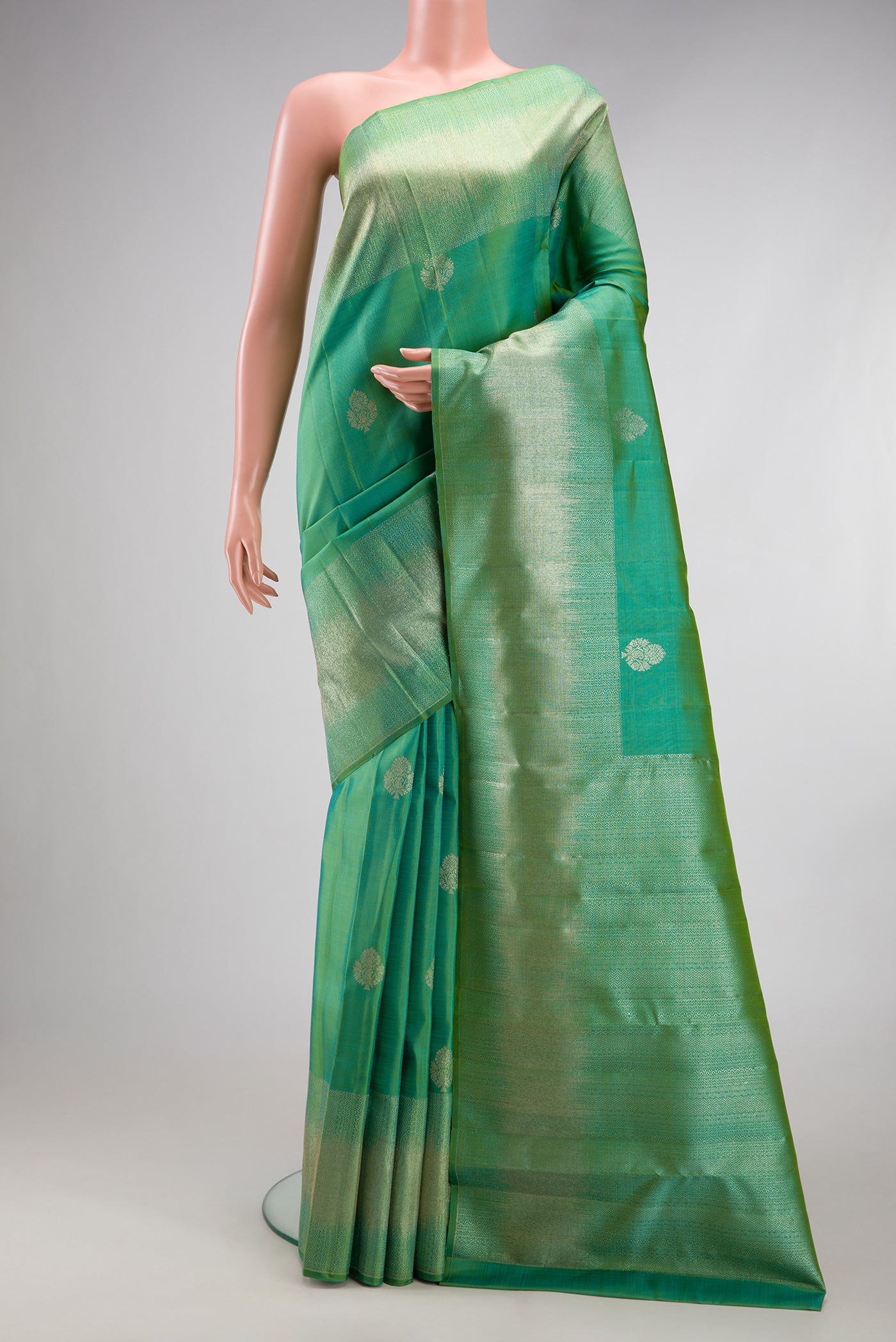 Sea Green Kanjivaram Silk Saree with Zari Butta on the body and Fancy Border.  displayed on a mannequin