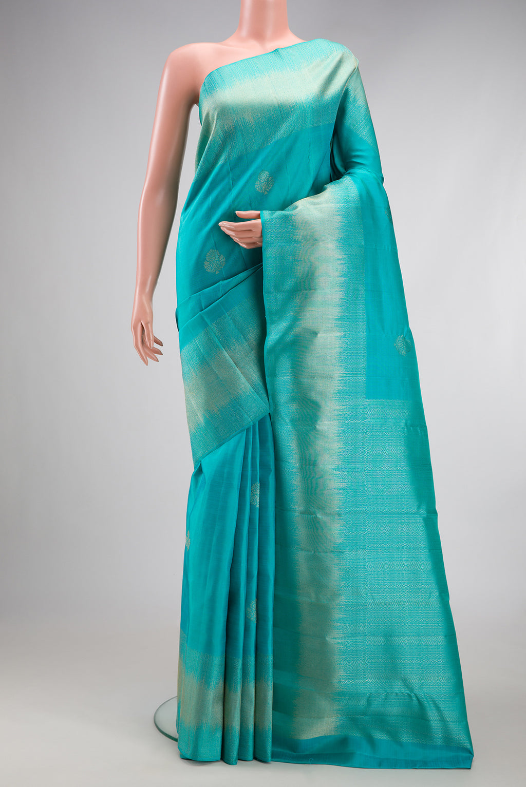 Sky Blue Kanjivaram Silk Saree with Zari Butta on the body and Fancy Border.  displayed on a mannequin
