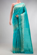 Sky Blue Kanjivaram Silk Saree with Zari Butta on the body and Fancy Border.  displayed on a mannequin