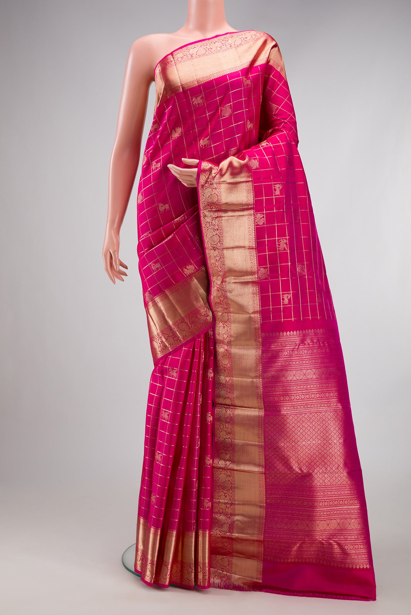 Dark Pink Kanchipuram Silk Saree with Checked design on the body and Zari Border.  displayed on a mannequin