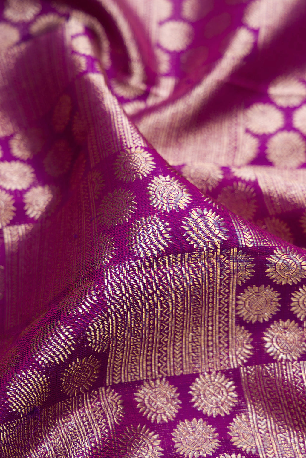 Close up of Purple Kanchipuram Silk Saree with Zari Brocade on the body and Zari Border.  displaying folds