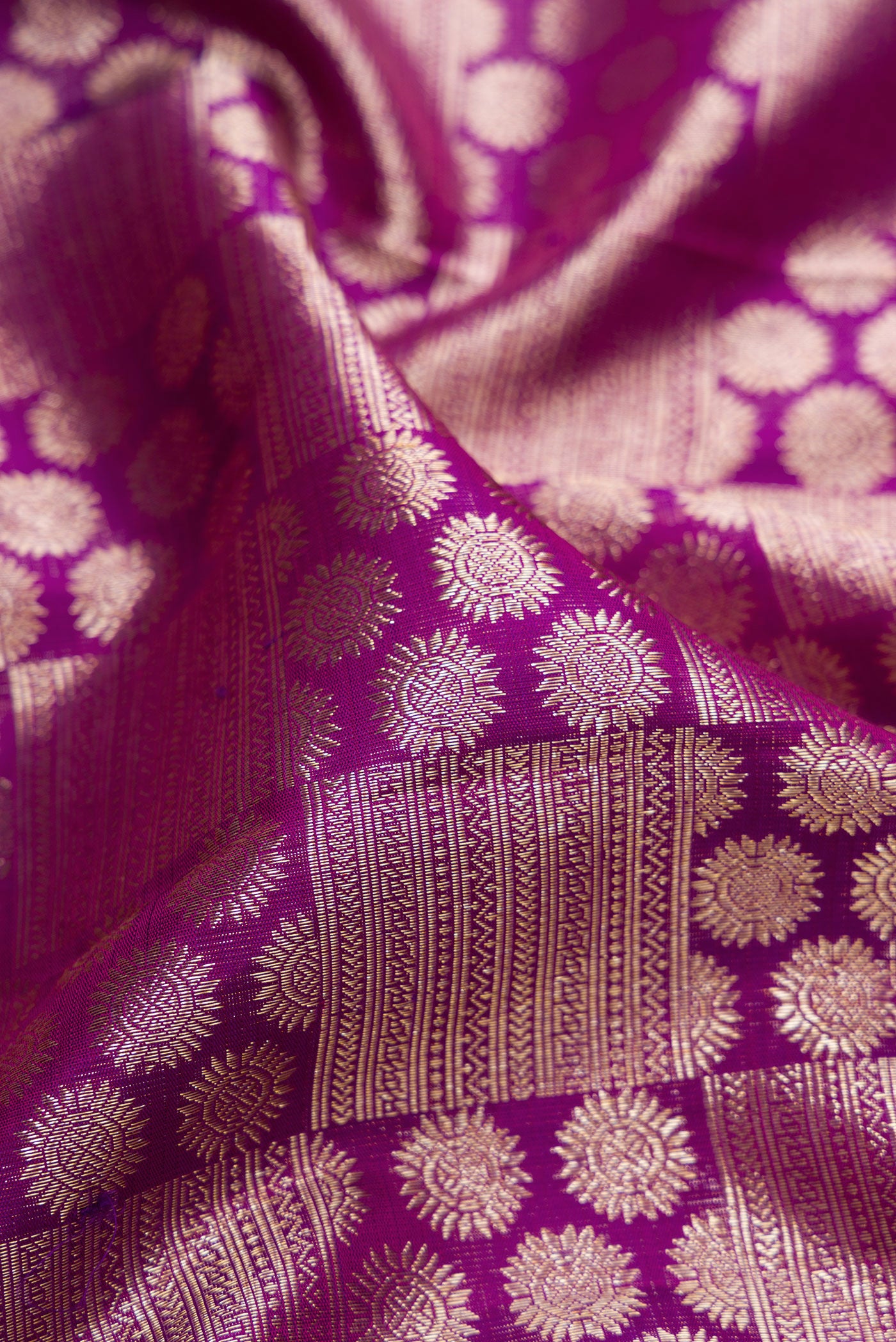 Close up of Purple Kanchipuram Silk Saree with Zari Brocade on the body and Zari Border.  displaying folds