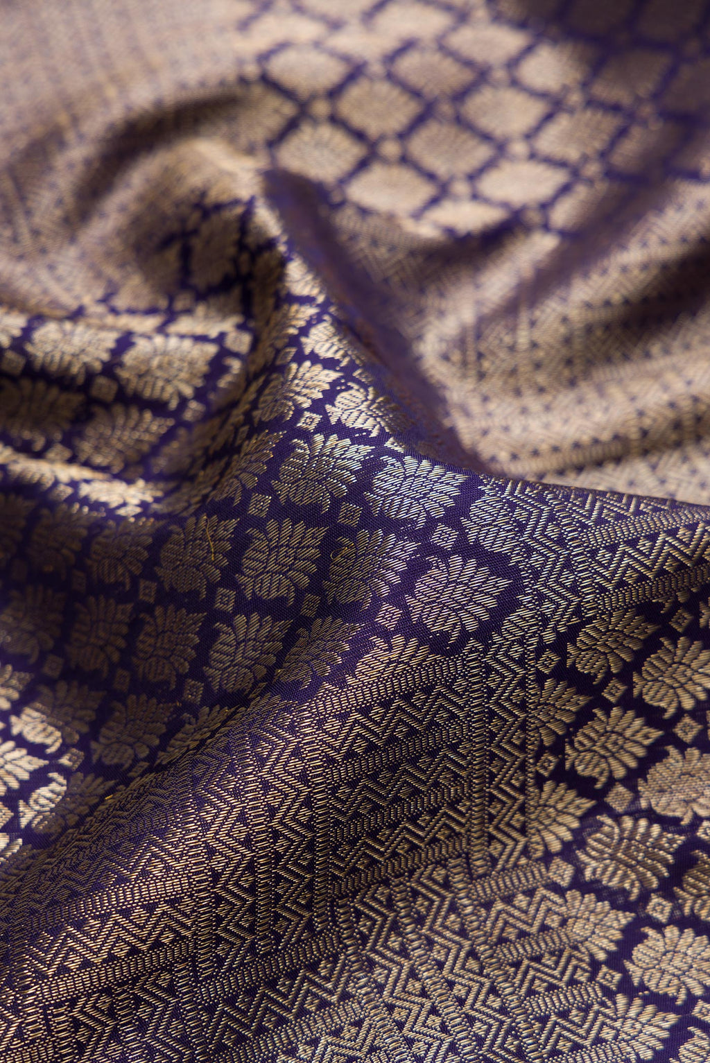 Close up of Navy Blue Kanchipuram Silk Saree with Zari Brocade on the body and Zari Border.  displaying folds