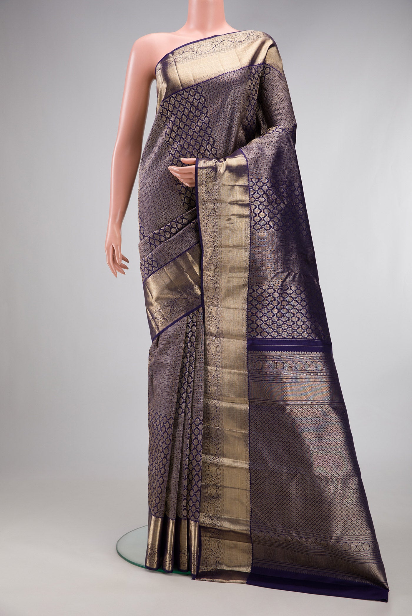 Navy Blue Kanchipuram Silk Saree with Zari Brocade on the body and Zari Border.  displayed on a mannequin