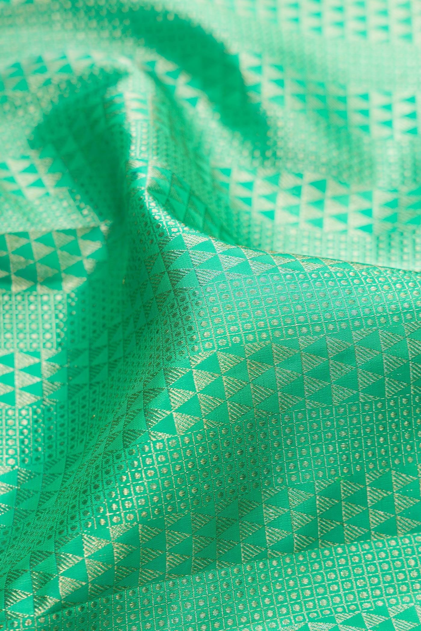 Close up of Sea Green Kanchipuram Silk Saree with Zari Brocade on the body and Zari Border.  displaying folds