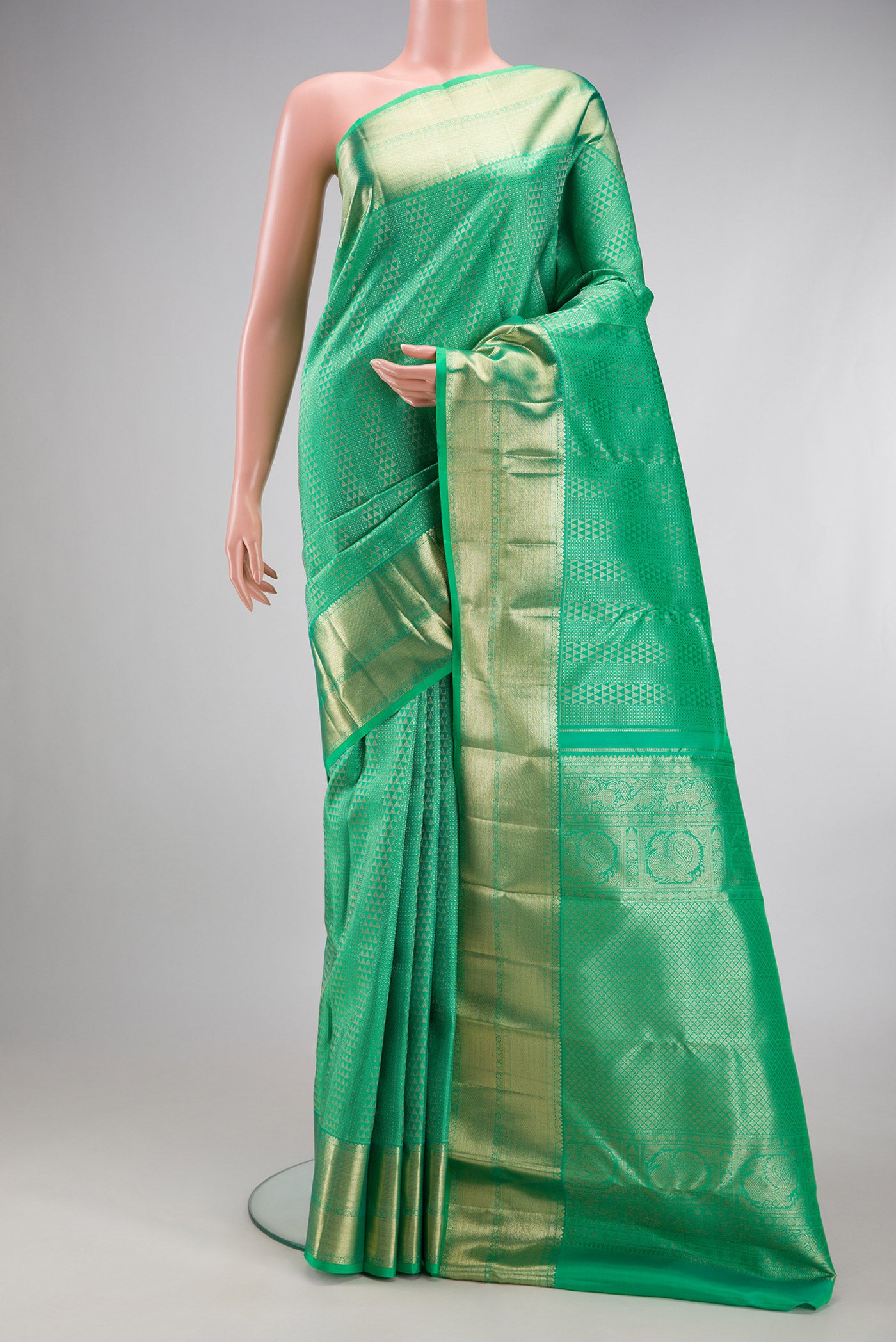 Sea Green Kanchipuram Silk Saree with Zari Brocade on the body and Zari Border.  displayed on a mannequin