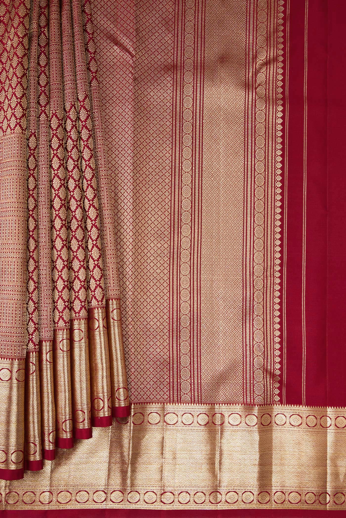 Pleats and pallu of Maroon Kanchipuram Silk Saree with Zari Brocade on the body and Zari Border. 
