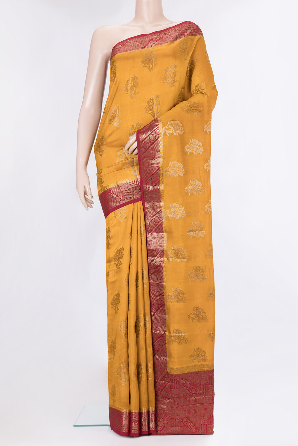 Mustard Tussar Silk Saree with Zari Butta on the body and Zari Border.  displayed on a mannequin