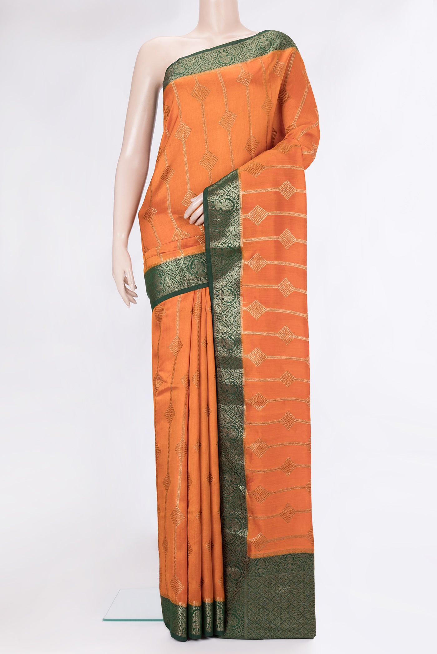 Orange Tussar Silk Saree with Zari Butta on the body and Zari Border.  displayed on a mannequin