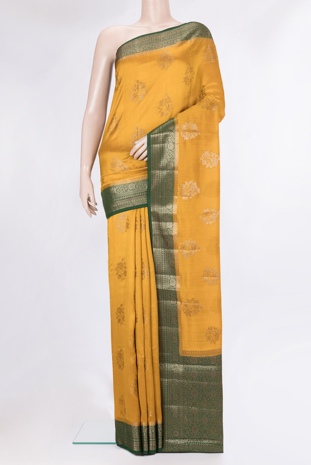 Mustard Tussar Silk Saree with Zari Butta on the body and Zari Border.  displayed on a mannequin