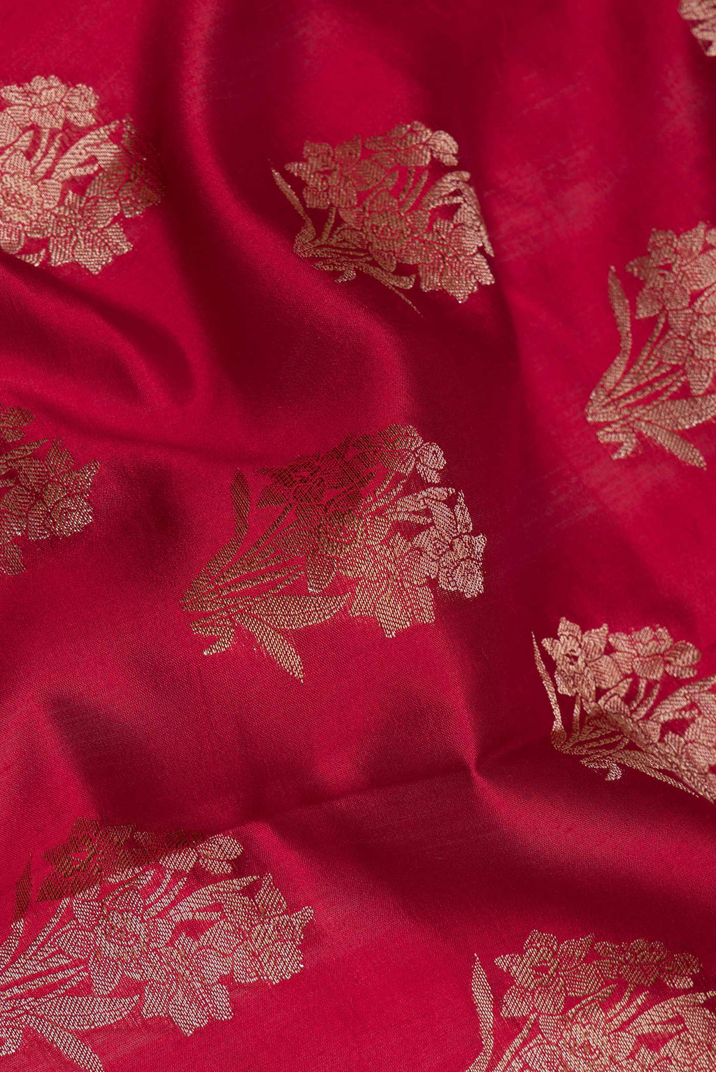 Close up of Maroon Tussar Silk Saree with Zari Butta on the body and Zari Border.  displaying folds