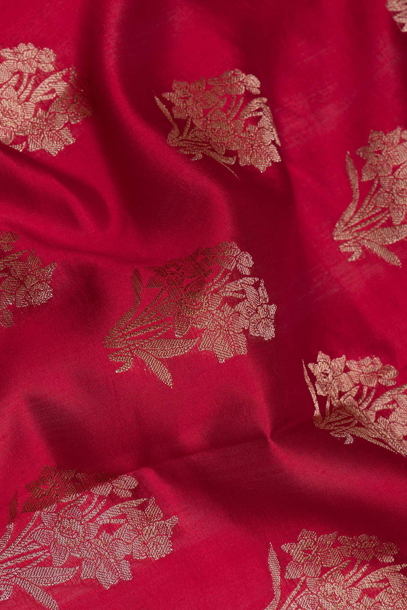 Close up of Maroon Tussar Silk Saree with Zari Butta on the body and Zari Border.  displaying folds