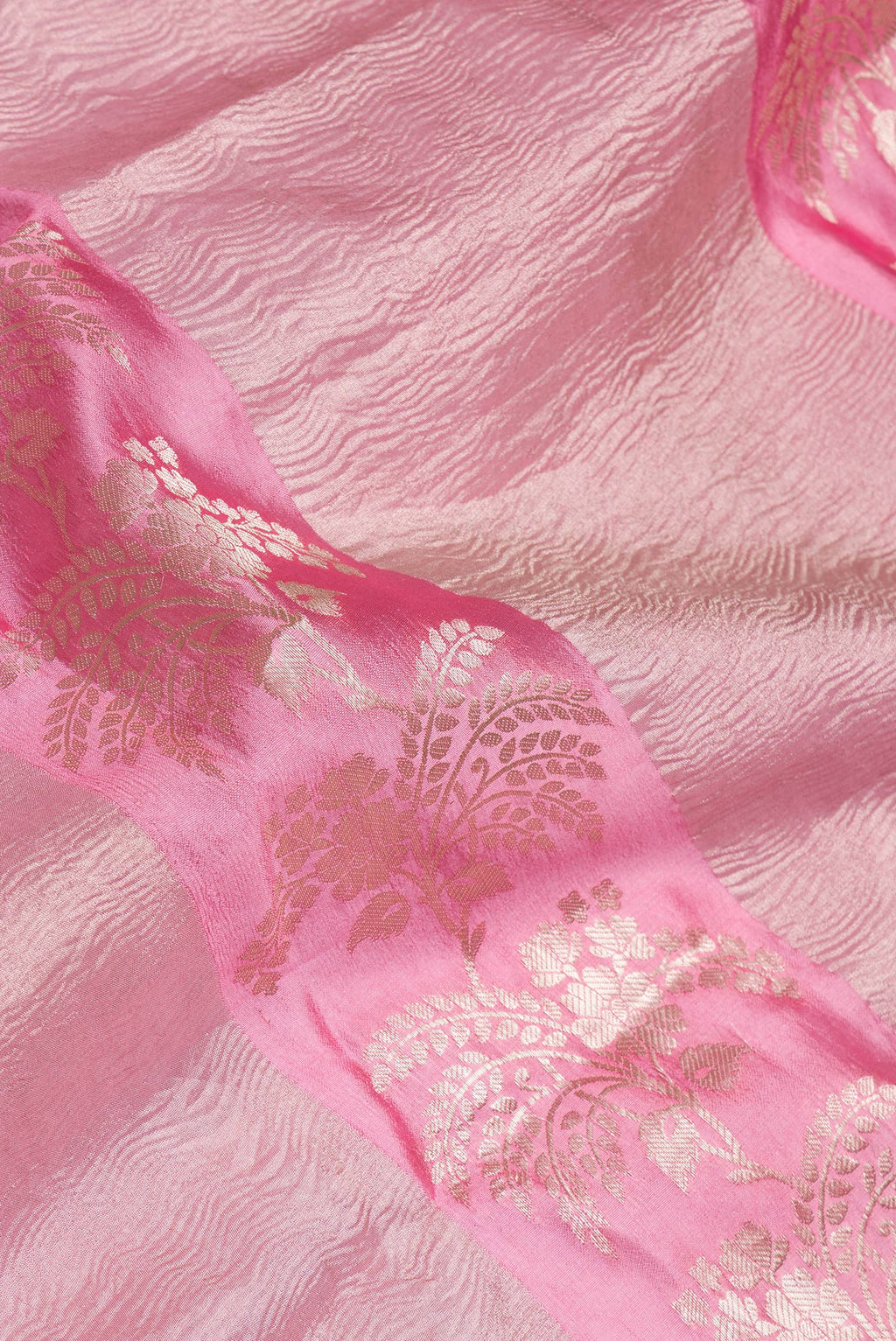 Close up of Pink Tussar Silk Saree with Zari Brocade on the body and Fancy Border.  displaying folds