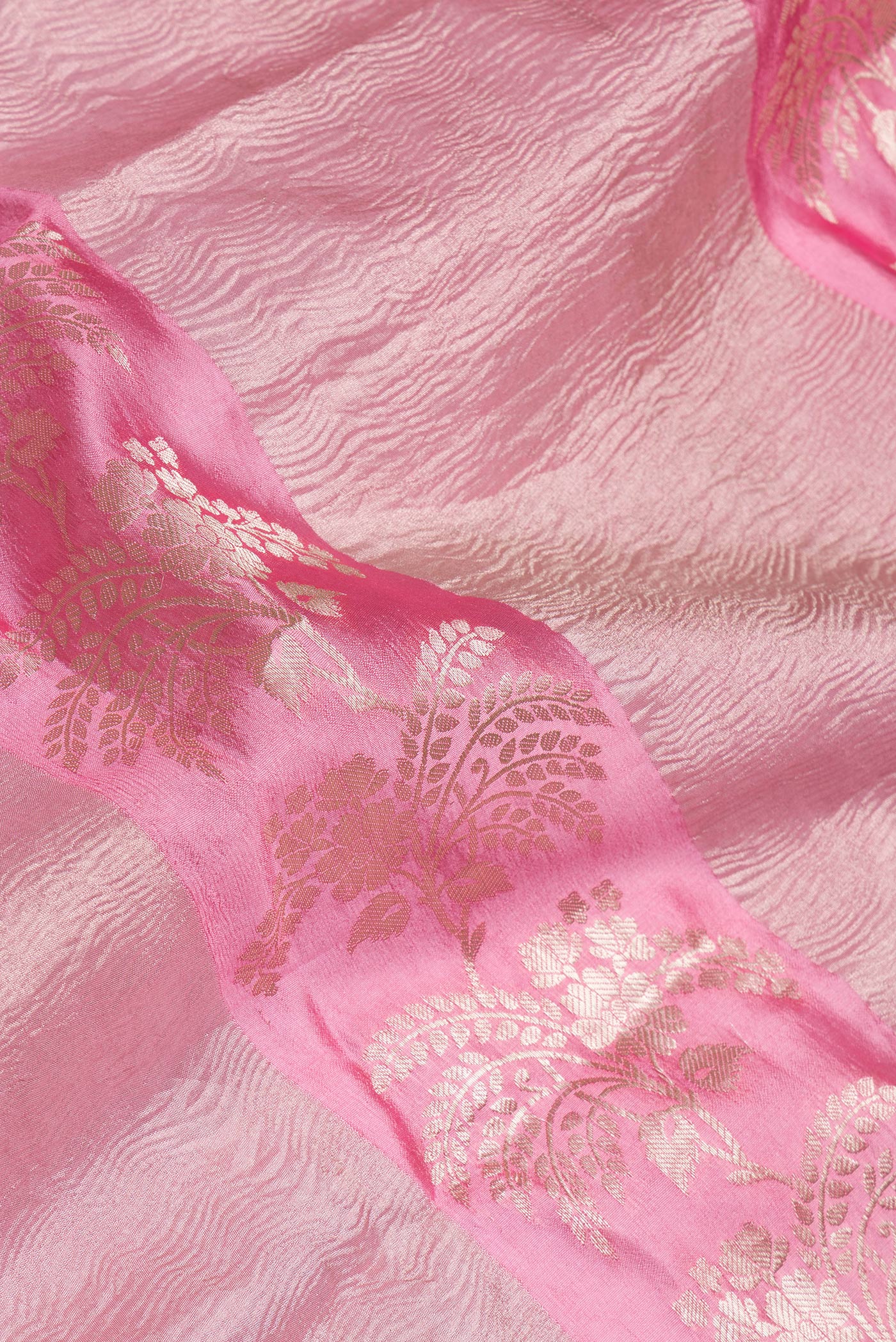 Close up of Pink Tussar Silk Saree with Zari Brocade on the body and Fancy Border.  displaying folds
